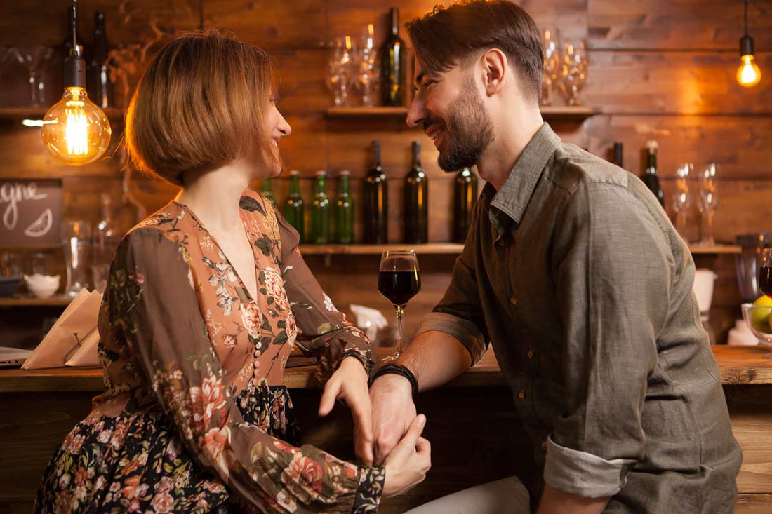 handsome-bearded-man-looking-deeply-into-his-girlfriend-and-brush-hand-on-her-hands