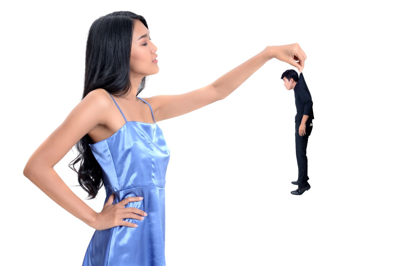 a girl frabing a boy as a toy and playing with him