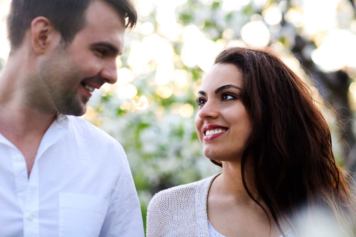 a couple staring at each other romantically and smile